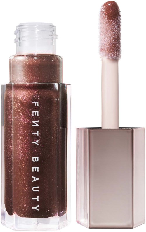 A brown glittery lip gloss with a stick applicator and clear packaging that says "Fenty Beauty."