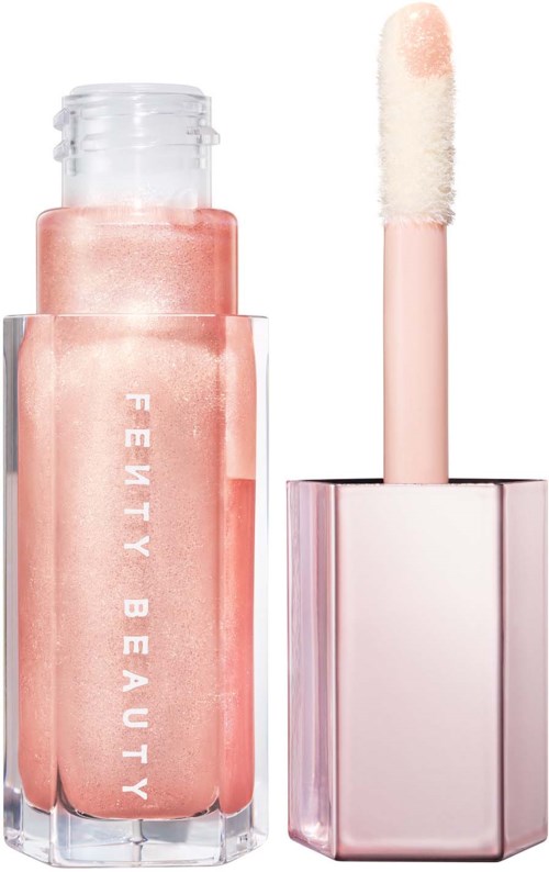A pink lip gloss in a transparent bottle with a white wand applicator.