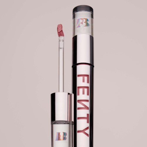 Lip gloss tube with a pink applicator and shiny silver packaging. The lip gloss appears light pink.