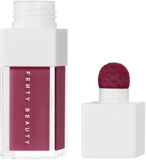 A lip gloss tube with a pink color and a matching applicator sponge. The tube has white text and a clean design.
