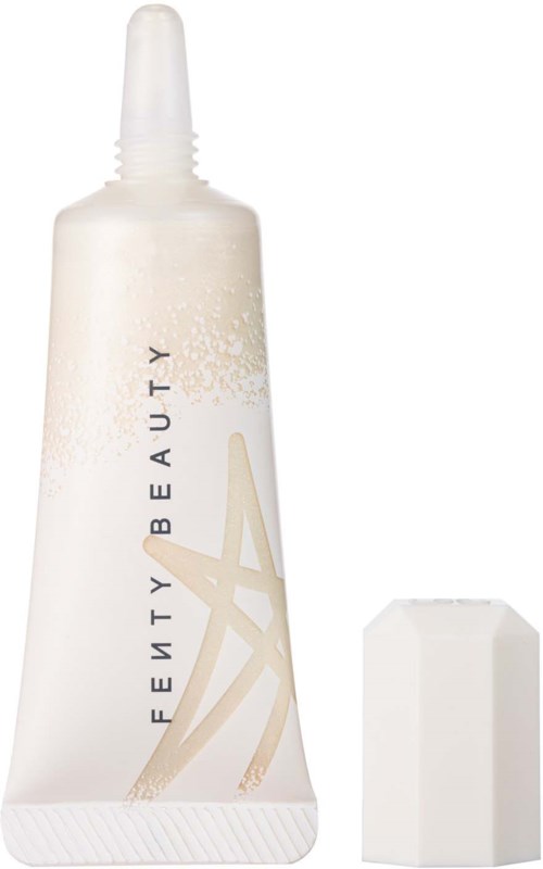 A white tube of beauty product with a pointed cap and a blank sponge beside it.