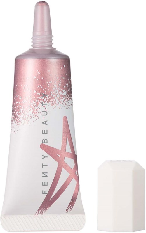 A pink and white tube with a cap, likely a cosmetic or skincare product, with a plastic sponge nearby.