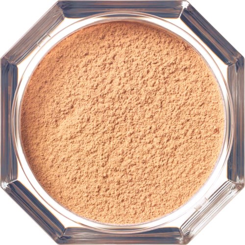 A round, open container with beige powder, possibly makeup or cosmetic product inside.