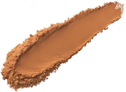 A smear of brown cosmetic powder, like foundation or face powder, on a black background.