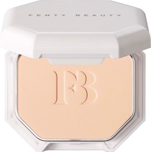 A compact with a beige powder and embossed '13' inside, in a white case labeled Fenty Beauty.