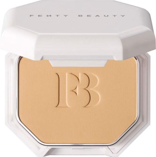 A compact makeup powder case with a beige powder and a raised 'B' logo on it.