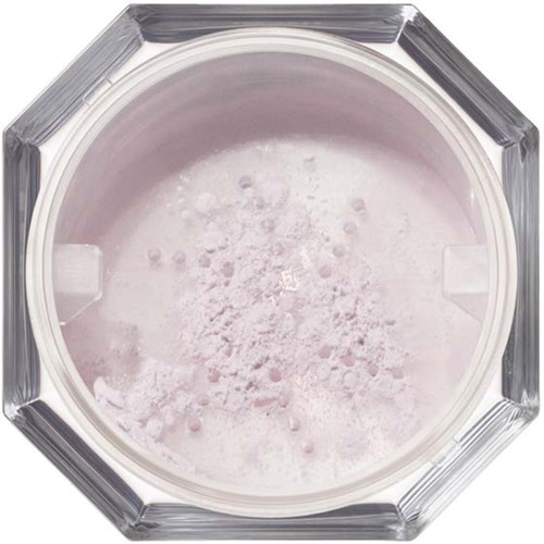 A round container with scattered white powder or flakes inside, viewed from above.