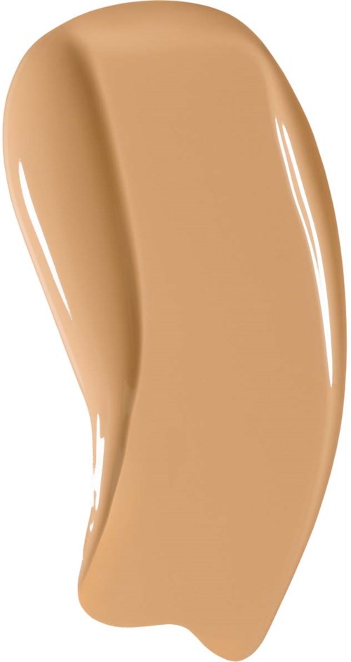 En virvel av beige flytande, slät och glänsande, troligen en foundation eller concealer i tub.