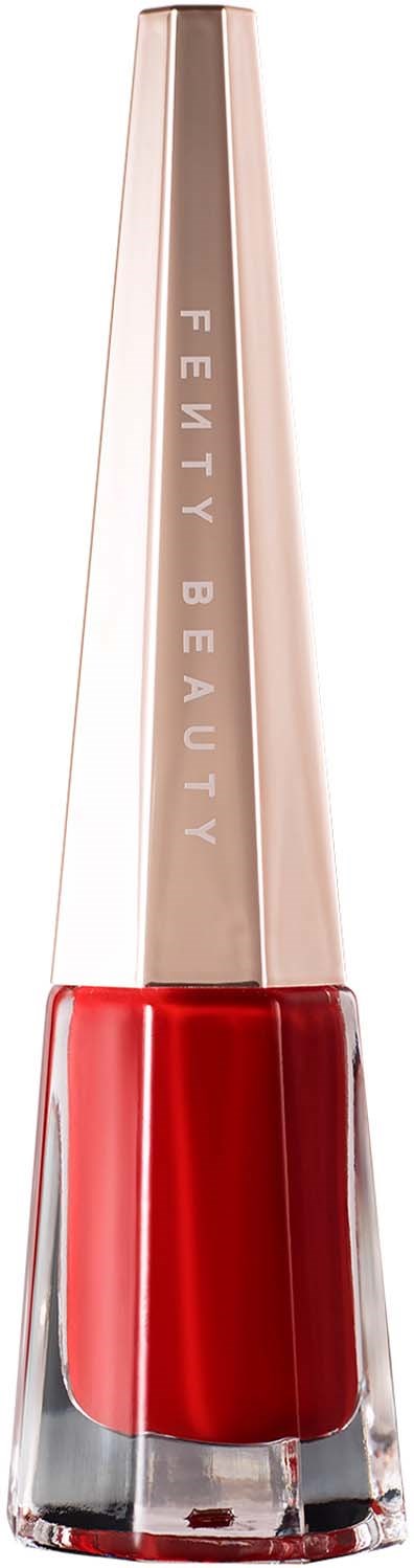 A lipstick with a clear base, bright red color, and a metallic gold cap that says 'Fenty Beauty'.