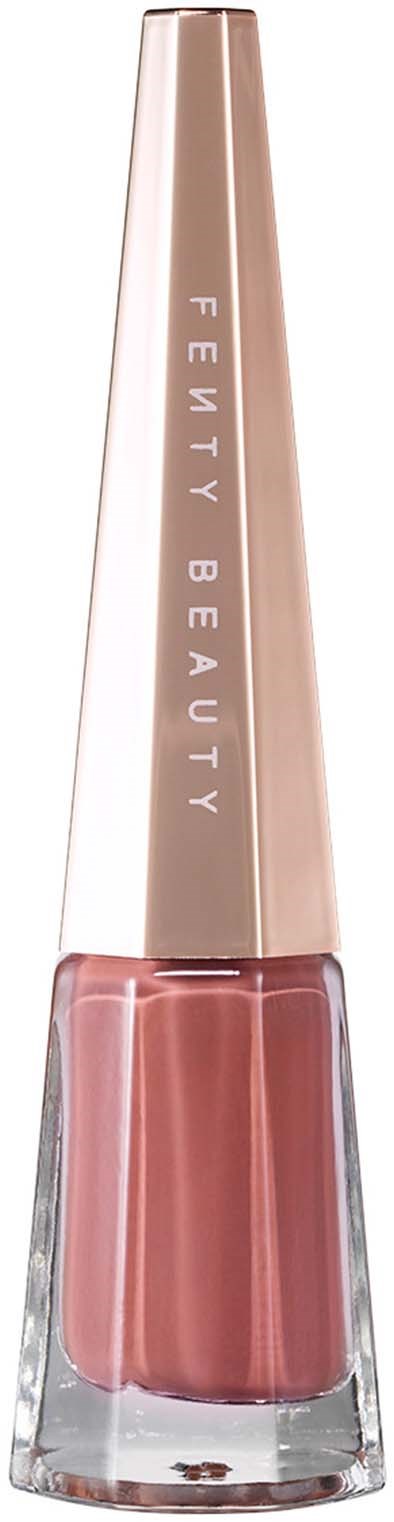A nail polish bottle with a pink shade and a tall, gold cap that says "FENTY BEAUTY."