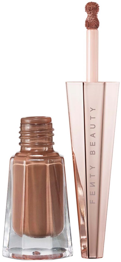 Lip gloss tube with a wand applicator, rose gold color, labeled 'Fenty Beauty'.