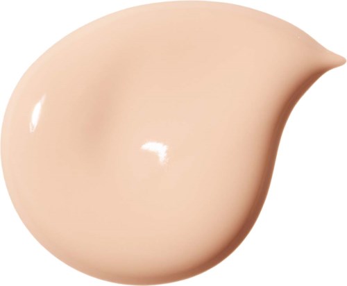 Ett beige kosmetikdropp med rund form och liten spets.