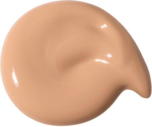 En beige flytande foundation i en virvlande form med en slät, glansig yta.