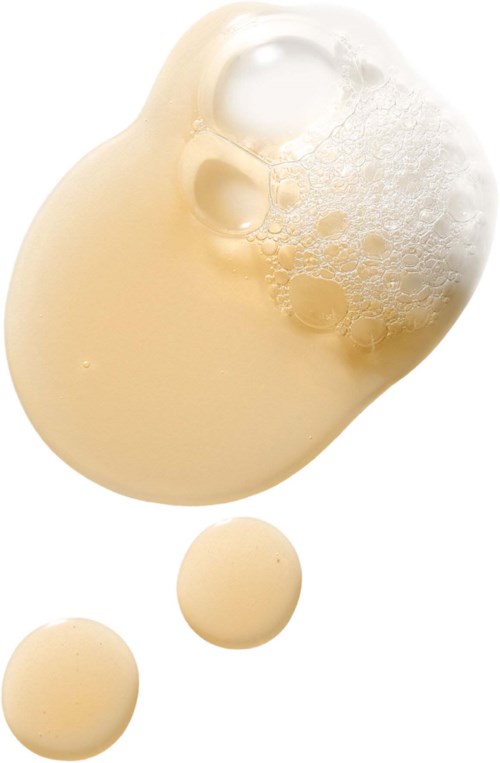 Creamy liquid with bubbles and two small round blobs below it.