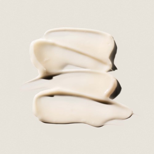 Three white blobs of cream or yogurt stacked on a plain background.