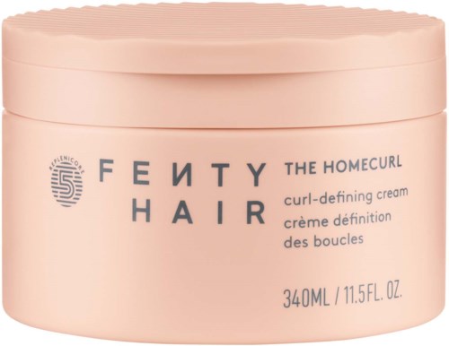 A round jar of Fenty Hair curl cream, pink color, with text and logo on the front.
