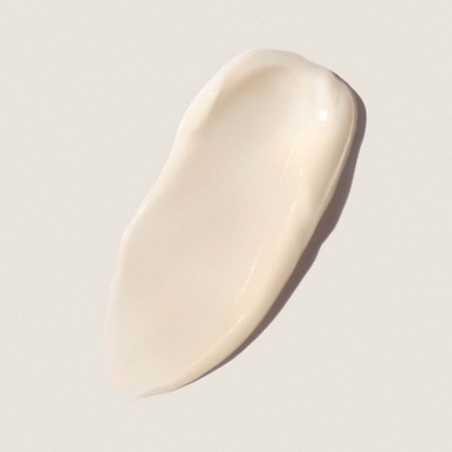 A smooth, cream-colored, curved shape with shiny surface, resembling a swatch or smear of cream or paint.