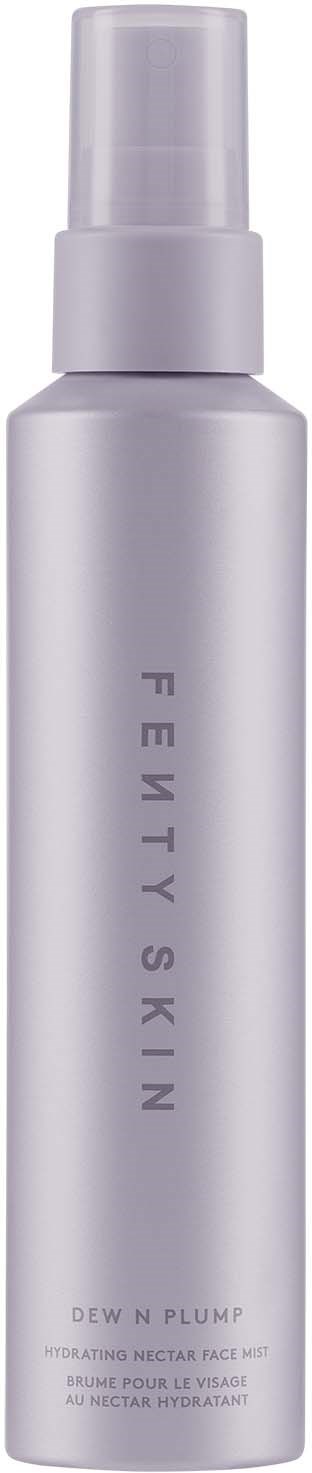 A tall, slim white bottle with a spray cap, labeled Fenty Skin Dew N Plump.