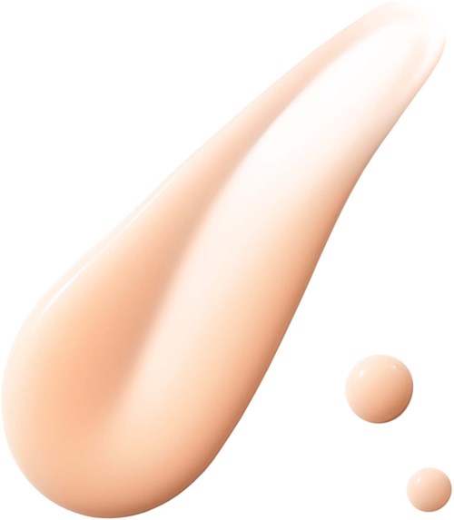 A large droplet of beige liquid with two smaller droplets nearby.