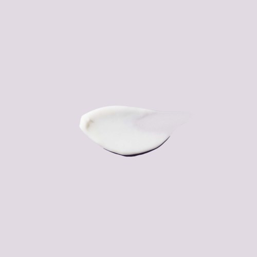 A white dollop of cream or yogurt on a plain light purple background.
