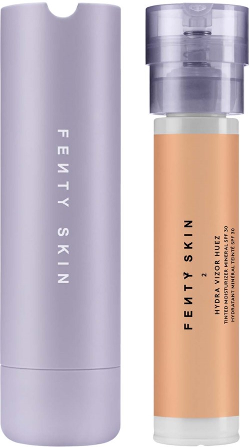A tall, purple and transparent bottle with Fenty Skin branding, likely a skincare product.