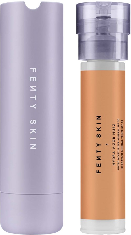 A skincare product with a tall, light purple bottle and a smaller, cylindrical bottle with orange liquid.
