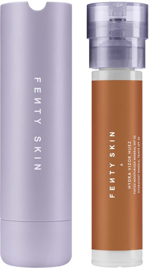 Two skincare bottles, one purple and tall, the other brown and shorter with a pump top. Both are labeled Fenty Skin.