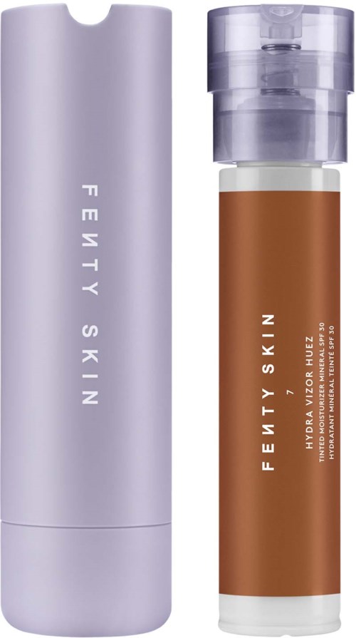A Fenty Skin bottle and packaging, brown liquid inside, clear cap, minimalistic design.