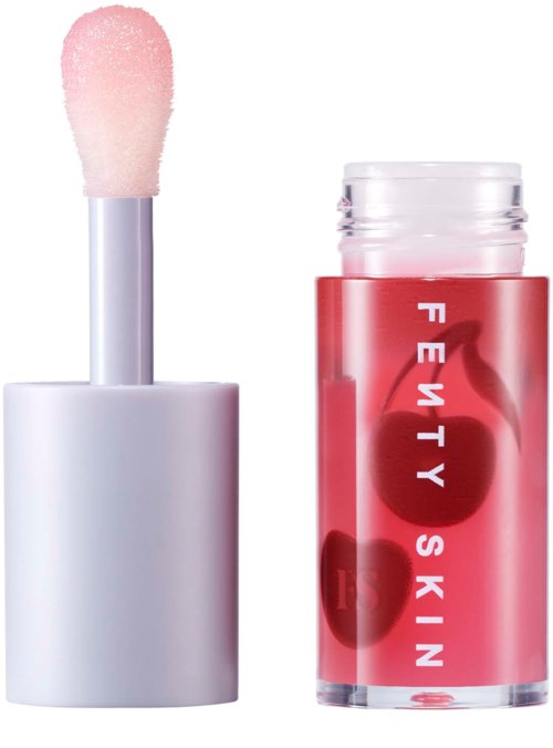 Lip gloss tube with a pink applicator and red container labeled 'Fenty Skin' featuring cherry graphics.