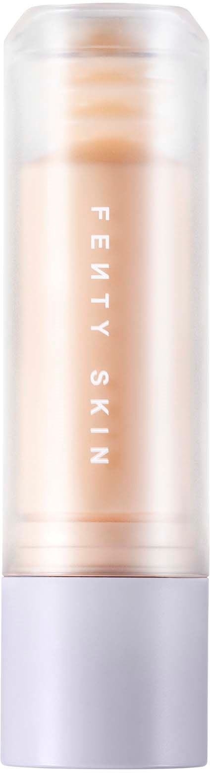 A cylindrical beige and silver tube labeled 'FENTY SKIN', likely a cosmetic or skincare product.