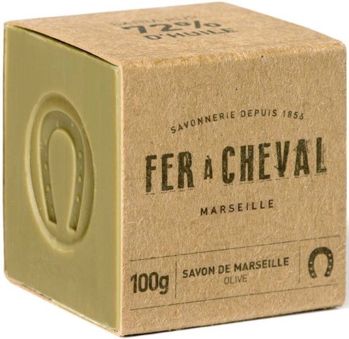 A brown soap box shows 'Fer à Cheval' with 'Marseille' and '100g' written on it, indicating olive soap from France.