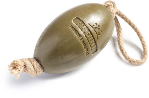 A green, oval-shaped soap with a rope attached, featuring a logo and text stamped on it.