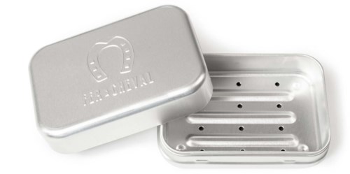 A silver metal box with a horseshoe logo and the words "BEAT HOLYAL" on the lid, empty inside with small holes.