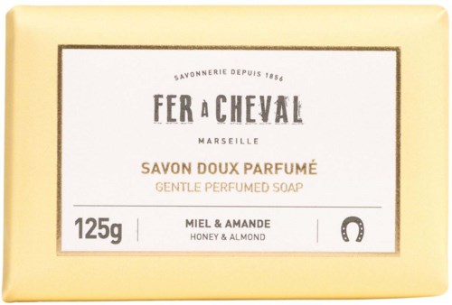 A beige soap box with black, brown, and gray text showing honey and almond scent. The brand is Fer a Cheval from Marseille.