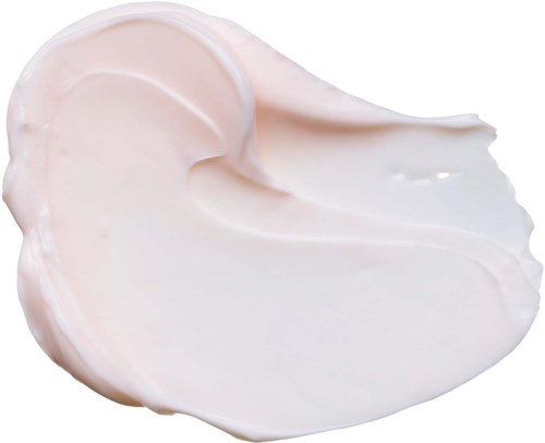 Ein Klecks weiße Creme ausgebreitet auf einer Oberfläche.