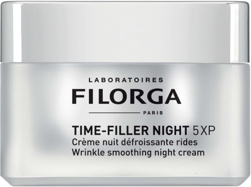A silver jar of Filorga Time-Filler Night cream, designed to reduce wrinkles and improve skin overnight.