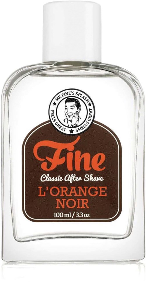 A clear bottle of aftershave named 'Fine' with an orange and black label, featuring a logo with a man's face.