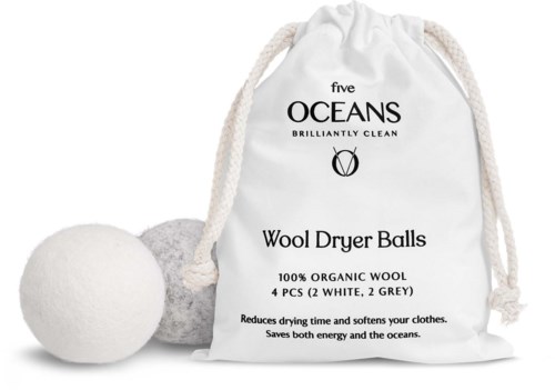 A white drawstring bag with black text and two wool dryer balls, one white and one grey.