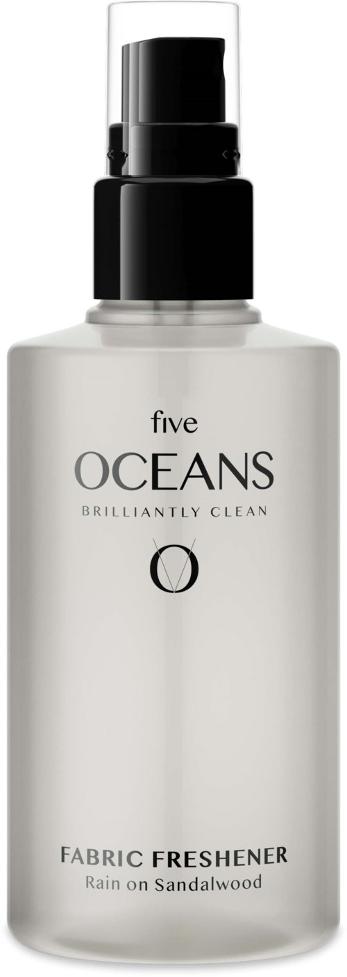 A white spray bottle with black cap, labeled as fabric freshener with a sandalwood scent.