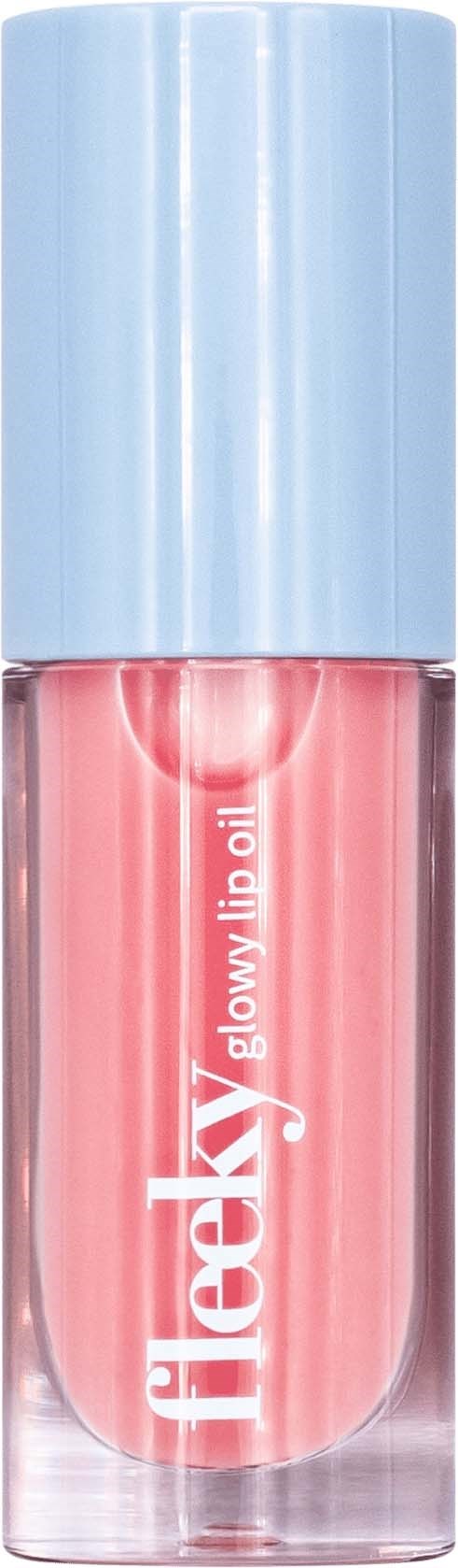 En liten rosa flaska med ljusblå lock, märkt 'helaxy', sannolikt nagel- eller läppolja.
