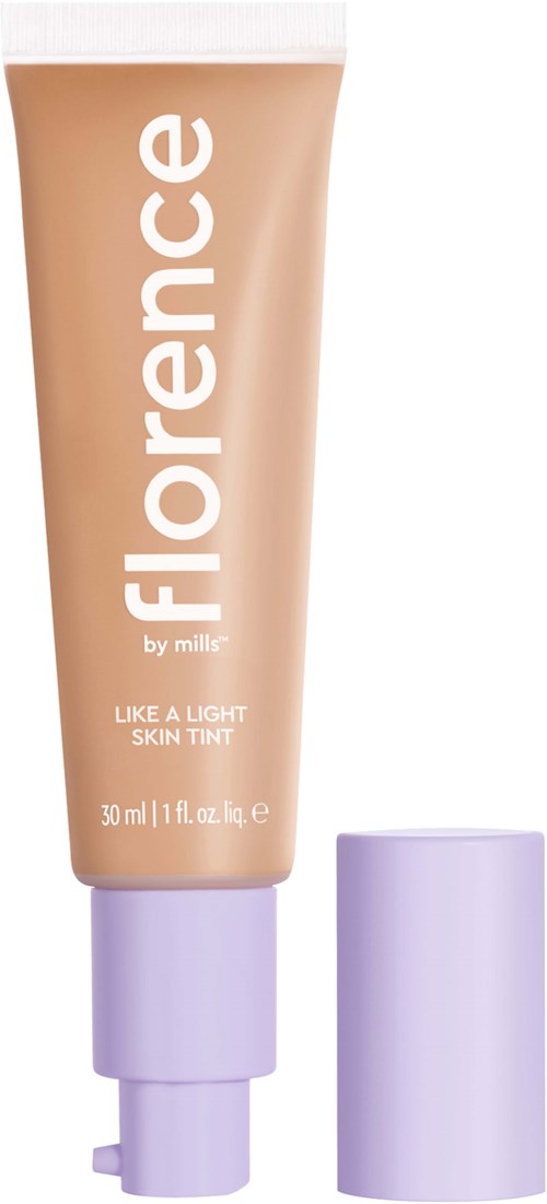 En tub med hudtint märkt 'Florence by mills' med lila lock, främjar ett ljust hudutseende.
