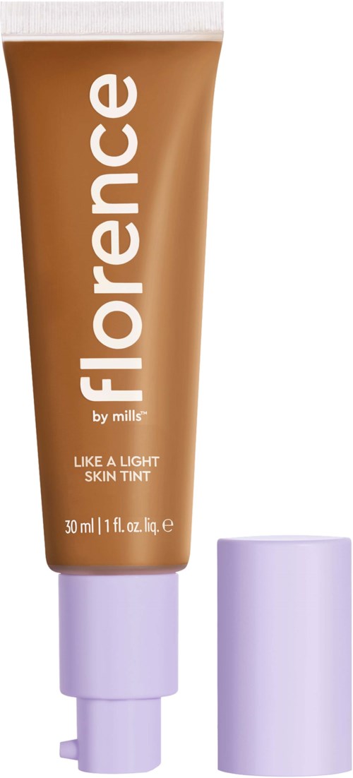 Orange tub med vitt lock märkt 'Florence by Mills' bredvid, innehållande lätt hudfärg.