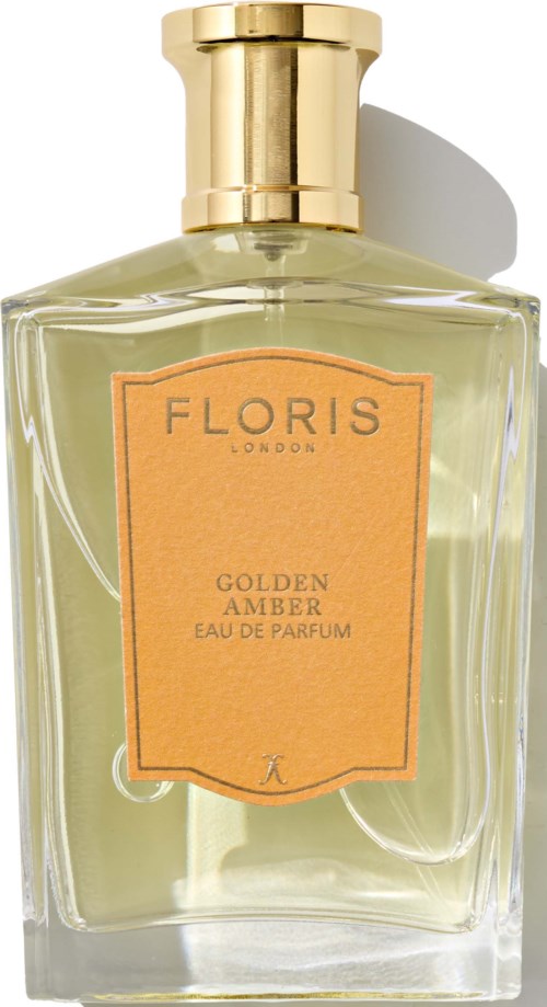 A perfume bottle with a golden cap and a peach label that says 'Floris London Golden Amber Eau de Parfum'.