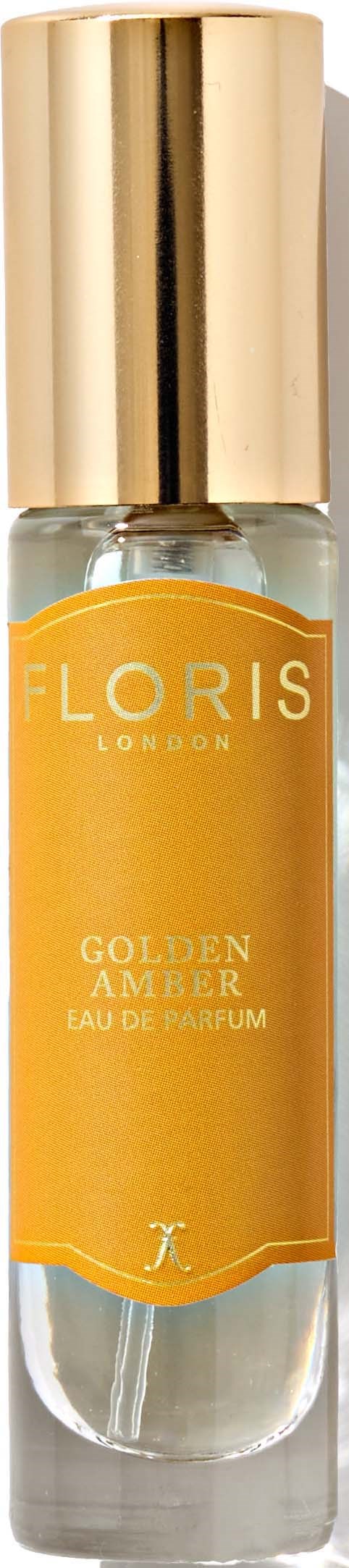 Een kleine parfumfles met een gouden dop en een geel label, met 'Florís London Golden Amber Eau de Parfum.'