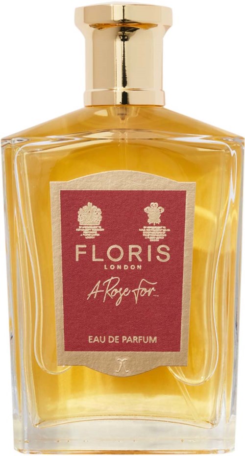 Een gele parfumfles met een gouden dop en een roze label met witte tekst en iconen.
