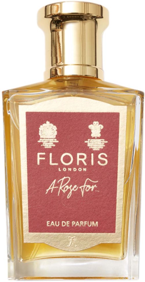 Ein Parfümflasche mit rosa Etikett, goldenem Verschluss und gelber Flüssigkeit, etiketti 'Floriss London' und 'A Rose for'.