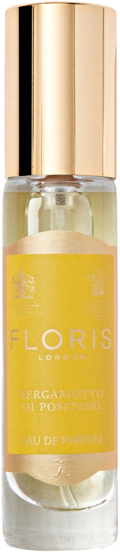 Een kleine parfumfles met een gouden dop en een gele label, gemarkeerd "BIERGAMOTTO DI POSITANO."