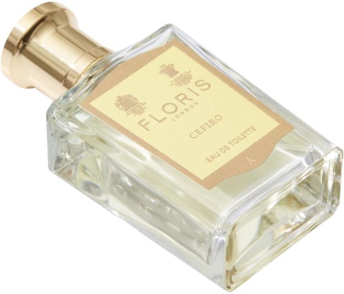 A clear glass perfume bottle with a gold cap and beige label, labeled Floris, Cépiro, Eau de Toilette.