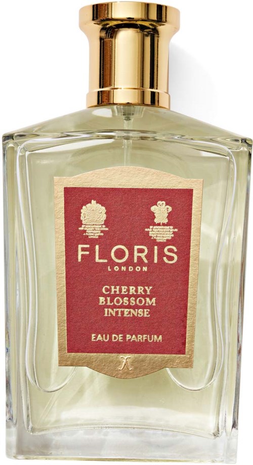 Een parfumfles met een rood label, gouden dop, en lichtgroen vloeistof binnenin. Het label zegt 'Floris London Cherry Blossom Intense.'