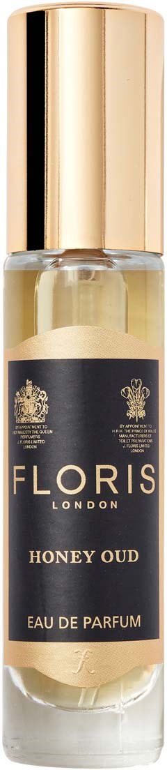 Mała butelka spray z złotą nakrętką, czarną etykietą i złotym napisem. Zawiera perfumy honey oud.